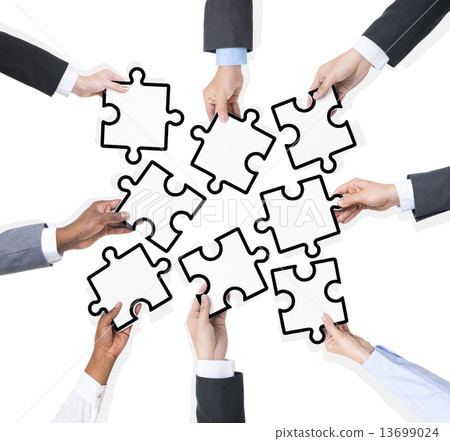 Group Of Business People Holding Pieces Of Puzzle 13699024