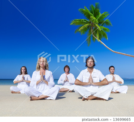 People performing yoga on the beach 13699665