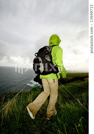 Woman Hinking Through The Cliffs Of Moher Woman Hinking Through The Cliffs Of Moher 13699715