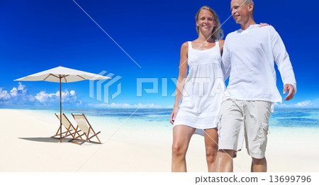 Couple Holding Each Other Walking By The Beach Couple Holding Each Other Walking By The Beach 13699796