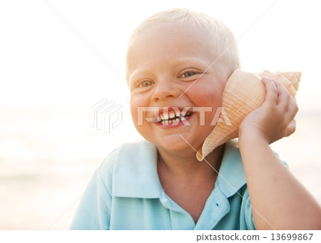 Little boy having fun on a beach 13699867