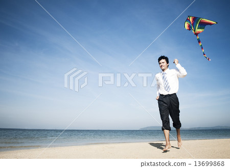 Businessman relaxing on the beach 13699868