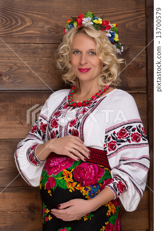 Ukrainian pregnant woman in vyshyvanka 13700579