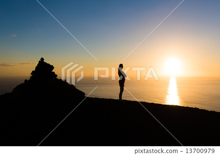 Romantic evening sunset at La Palma island with women's silhoette. 13700979