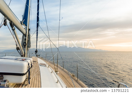 Sailing boat under power in calm seas 13701221