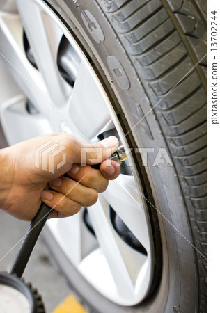 Man's hand checking tyre pressure. Man's hand checking tyre pressure. 13702244