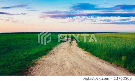 Dirty Rural Road In Countryside Field At Sunset 13703563
