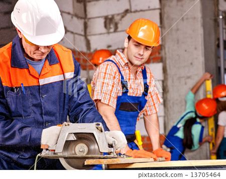 Group people  builder with circular saw . 13705464