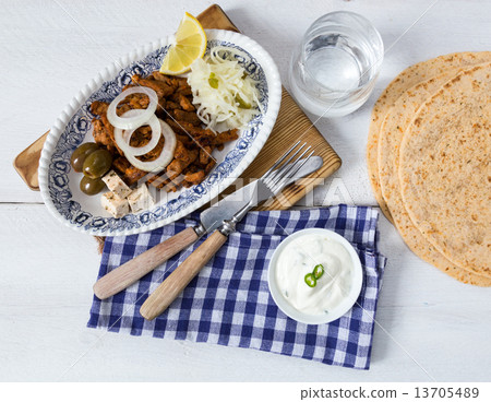 Gyros with Tzatziki Coleslaw olives and feta cheese 13705489