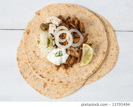 Gyros pita with tzatziki coleslaw olives and feta cheese 13705494