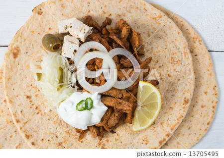Gyros pita with tzatziki coleslaw olives and feta cheese Gyros pita with tzatziki coleslaw olives and feta cheese 13705495