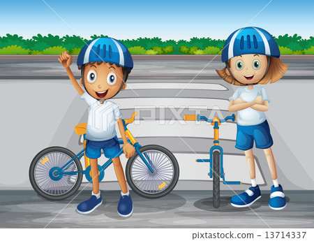 A girl and a boy with their bikes standing near the pedestrian l 13714337