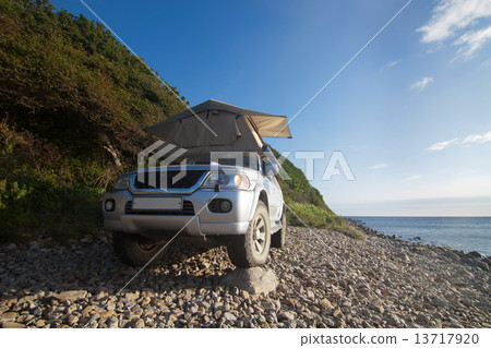 Car with rooftop tent on it 13717920