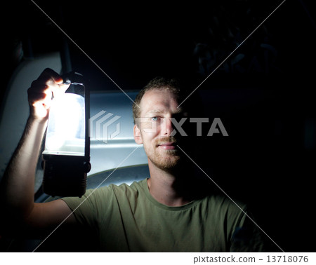 Man with lantern 13718076