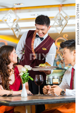 Chinese waiter serving dinner in elegant restaurant or Hotel 13719446