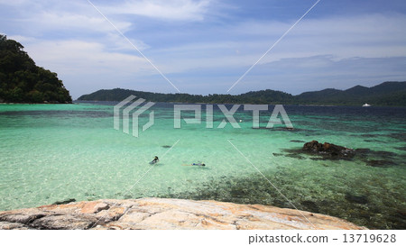 Two ladies snorkeling on a turquoise tropical sea 13719628