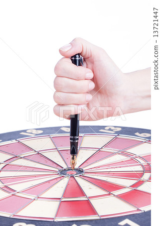 female hand sticks a Fountain pen in the target center 13721447