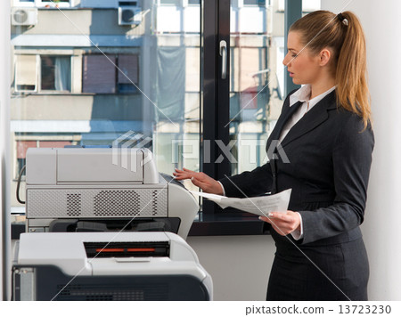 business woman working on printer business woman working on printer 13723230