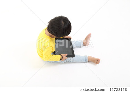 Child playing with Tablet pc touch pad  13728158