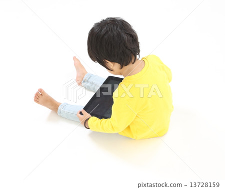 Child playing with Tablet pc touch pad  13728159