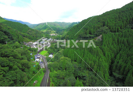 A village surrounded by forest 13728351