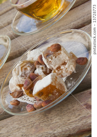 Turkish delight with pistachio seeds on the plate Turkish delight with pistachio seeds on the plate 13728773