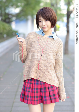 A woman listening to music A woman listening to music 13729527