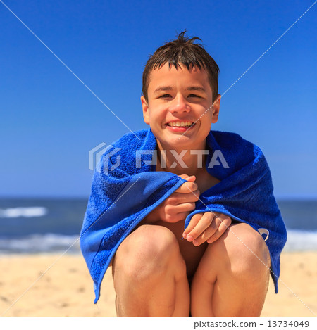 Happy young boy on the sea beach Happy young boy on the sea beach 13734049