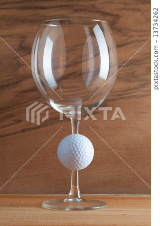 Glass of wine and golf ball 13734262