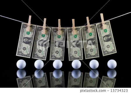 Dirty US dollar banknotes and golf balls Dirty US dollar banknotes and golf balls 13734323