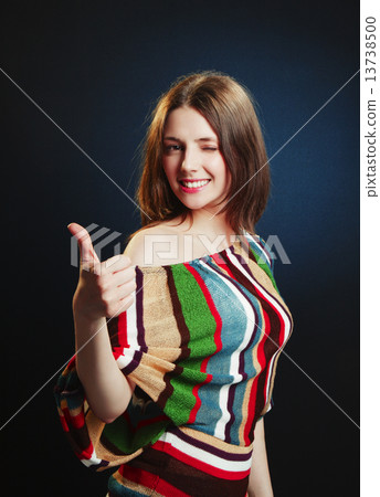 Young attractive female with thumbs-up 13738500