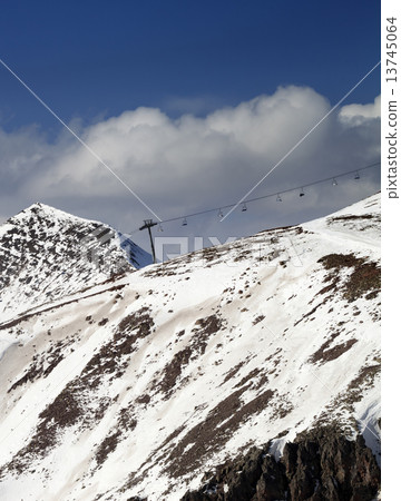 Off-piste slope and chair-lift in little snow year 13745064