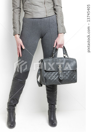 detail of standing woman wearing grey boots with a handbag detail of standing woman wearing grey boots with a handbag 13745405