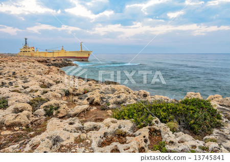 Ship aground near rocky coast 13745841