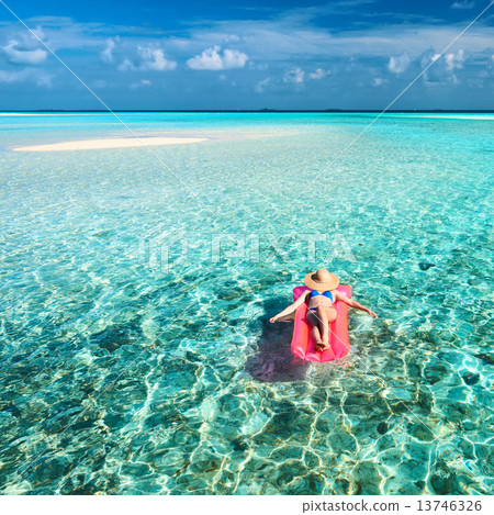 Woman relaxing on inflatable mattress 13746326