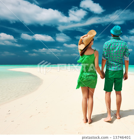 Couple in green on a beach at Maldives 13746401