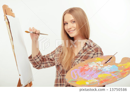 Stock Photo: Young beautiful artist creating a masterpiece