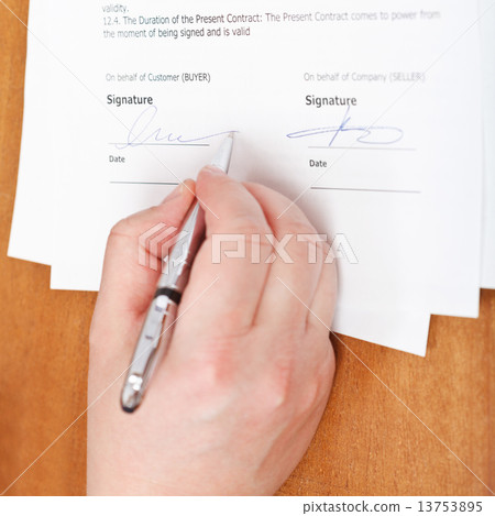businessman signs an agreement by silver pen businessman signs an agreement by silver pen 13753895