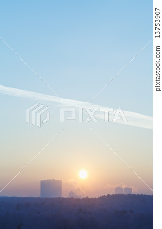 sunrise sun in blue sky over city in cold winter 13753907