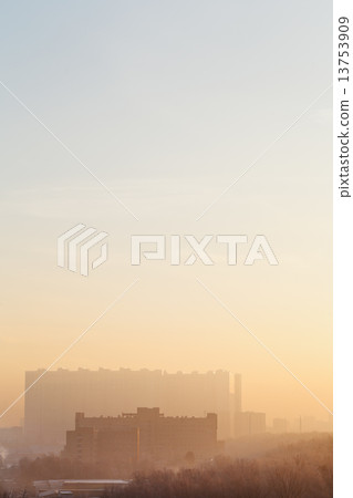 yellow and blue sunrise sky over urban houses 13753909