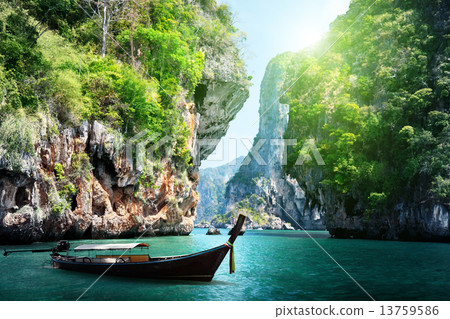 long boat and rocks on railay beach in Krabi, Thailand 13759586