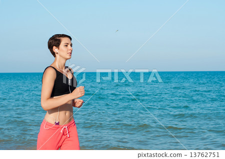 Young beautiful girl athlete on the beach in summer 13762751