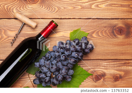 Red wine bottle and bunch of red grapes 13763352