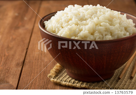 bowl full of rice on wood 13763579