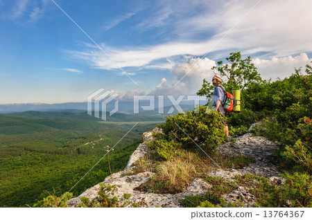 Hiking man in rays of sunset Hiking man in rays of sunset 13764367