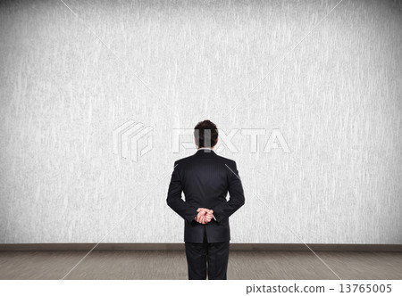 businessman looking to wall businessman looking to wall 13765005