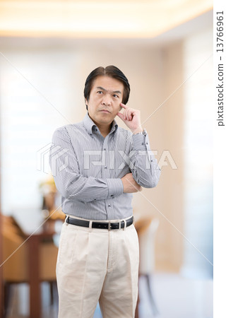 Middle-aged man in casual wear standing at home living 13766961