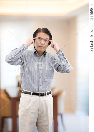 Middle-aged man in casual wear standing at home living 13766966