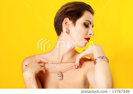 Young beautiful girl with a gold jewelry 13767886
