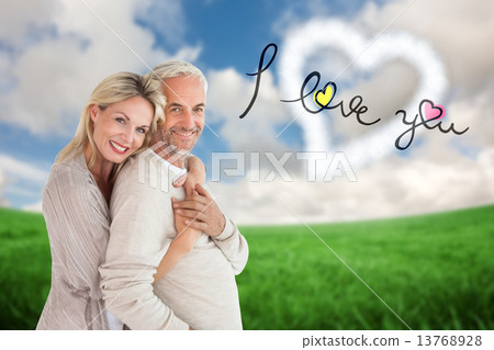 Composite image of happy couple standing and hugging Composite image of happy couple standing and hugging 13768928